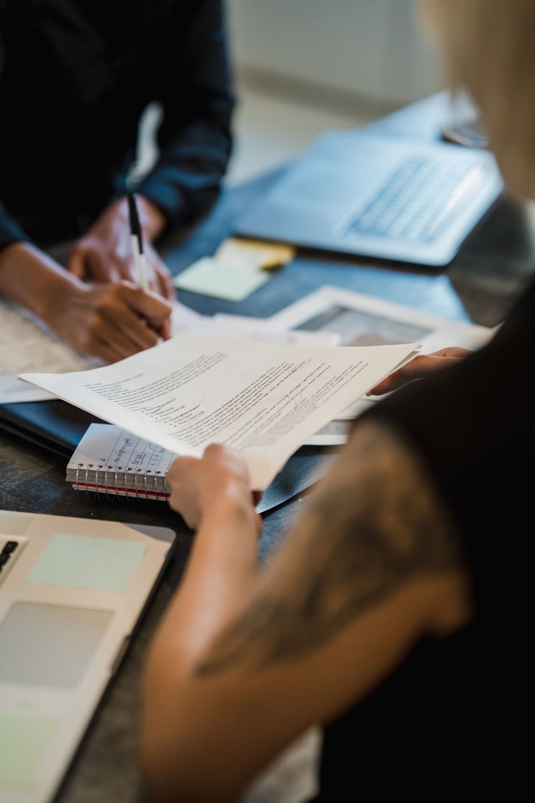 Professionals reviewing and signing documents