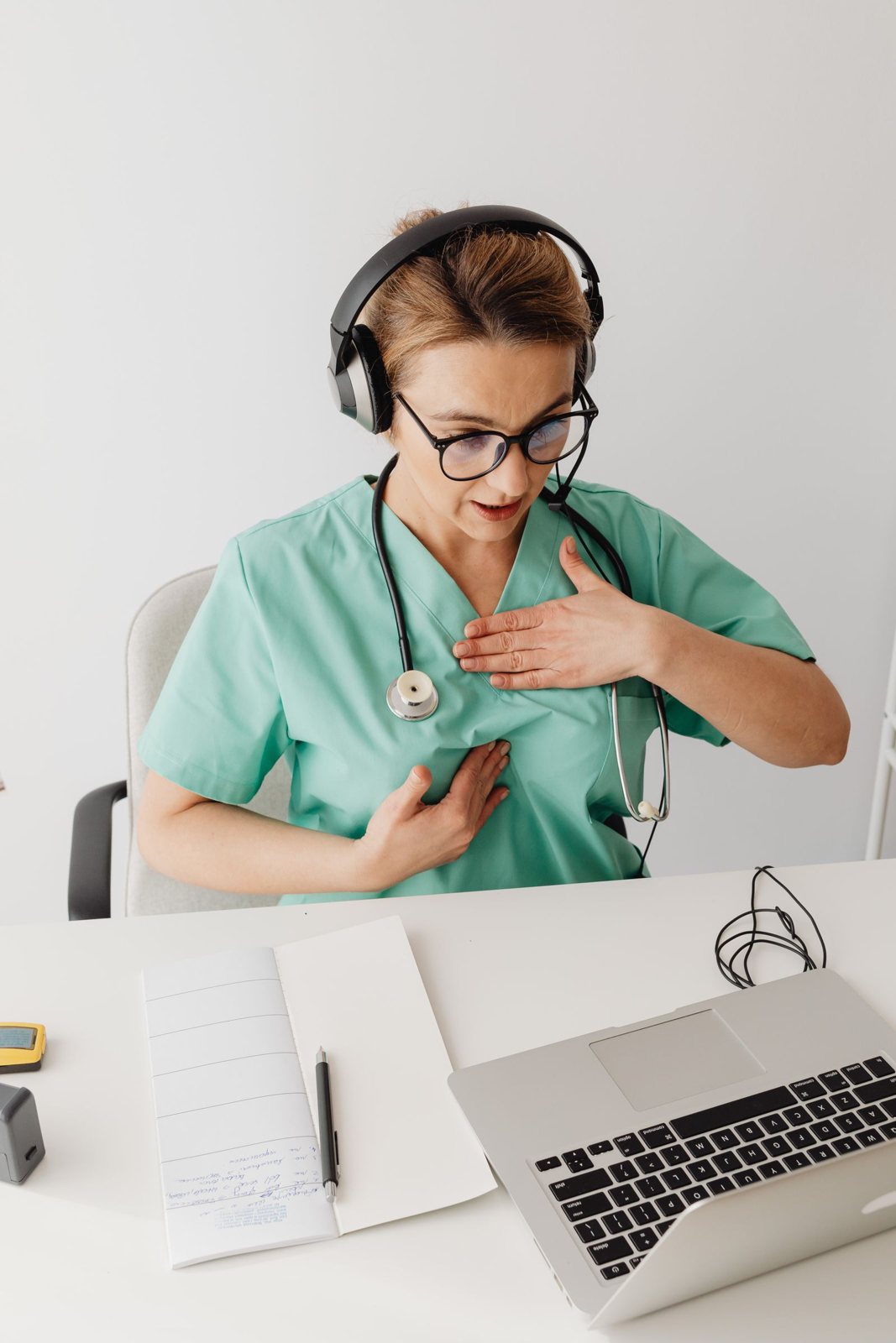 A healthcare interpreter in scrubs with a headset