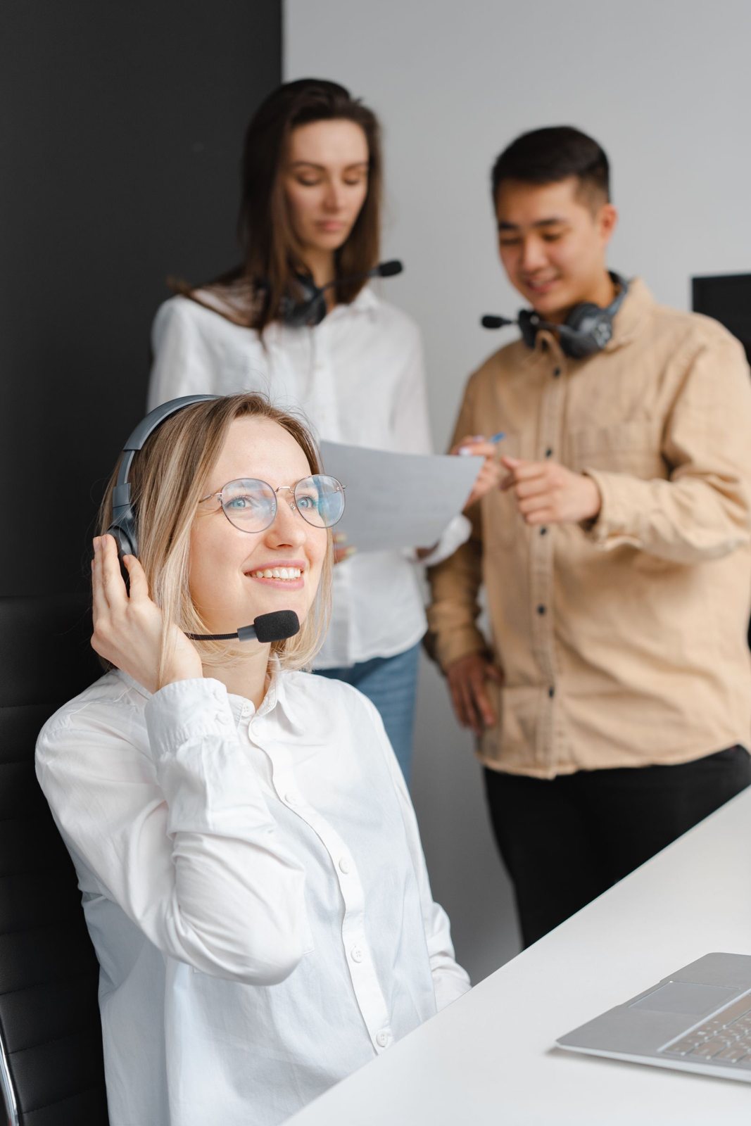 A smiling language professional with a headset at work